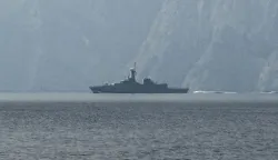 A navy vessel is seen sailing in the Strait of Hormuz, a vital waterway through which much of the world's oil and gas passes on March 1, 2026. Two ships were attacked in the Strait of Hormuz on March 1, maritime security agencies said, as Iran pressed a second day of strikes in response to US-Israeli military strikes on Iran killing it's supreme leader. (Photo by Sahar AL ATTAR/AFP)