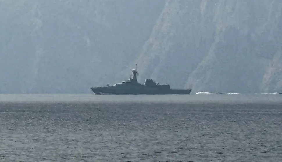 A navy vessel is seen sailing in the Strait of Hormuz, a vital waterway through which much of the world's oil and gas passes on March 1, 2026. Two ships were attacked in the Strait of Hormuz on March 1, maritime security agencies said, as Iran pressed a second day of strikes in response to US-Israeli military strikes on Iran killing it's supreme leader. (Photo by Sahar AL ATTAR/AFP)