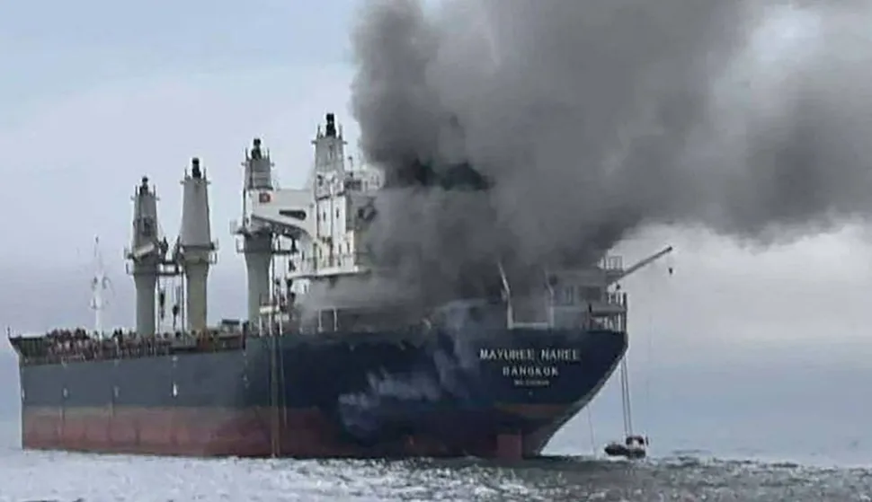 This handout photo taken on March 11, 2026 and released by the Royal Thai Navy shows smoke rising from the Thai bulk carrier 'Mayuree Naree' near the Strait of Hormuz after an attack. A Thai bulk carrier travelling in the crucial Strait of Hormuz was attacked March 11, with 20 crew members rescued so far, the Thai navy said. (Photo by Handout/ROYAL THAI NAVY/AFP)/-----EDITORS NOTE --- RESTRICTED TO EDITORIAL USE - MANDATORY CREDIT "AFP PHOTO/ROYAL THAI NAVY " - NO MARKETING - NO ADVERTISING CAMPAIGNS - DISTRIBUTED AS A SERVICE TO CLIENTS -
