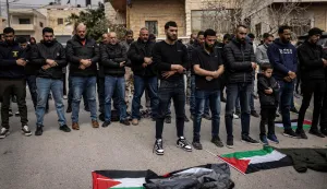 Friends and family pray during the funeral of 19-year-old Nasrallah Mohammad Siam, the day after he was killed in an Israeli settler attack, in the village of Mikhams, northeast of Jerusalem, in the Israeli-occupied West Bank on February 19, 2026. Violence in the Palestinian West Bank, which Israel has occupied since 1967, has soared since the Hamas attack on Israel triggered the Gaza war in October 2023. (Photo by JOHN WESSELS/AFP)