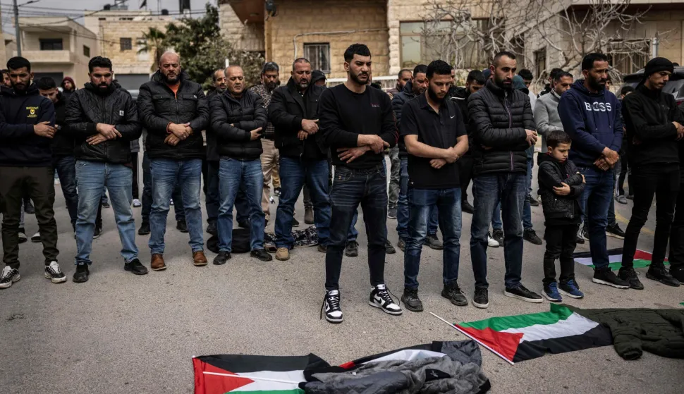 Friends and family pray during the funeral of 19-year-old Nasrallah Mohammad Siam, the day after he was killed in an Israeli settler attack, in the village of Mikhams, northeast of Jerusalem, in the Israeli-occupied West Bank on February 19, 2026. Violence in the Palestinian West Bank, which Israel has occupied since 1967, has soared since the Hamas attack on Israel triggered the Gaza war in October 2023. (Photo by JOHN WESSELS/AFP)