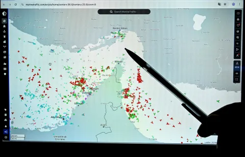 A person points at a page on the Marinetraffic website that shows commercial boats traffic on the edge of the Strait of Hormuz near the Iranian coast, in Paris on March 4, 2026. (Photo by JULIEN DE ROSA/AFP)