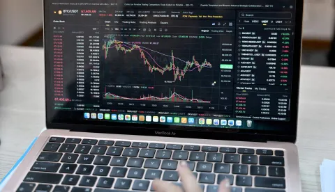 This photo taken on February 12, 2026 shows a Vietnamese cryptocurrency investor looking at the latest Bitcoin values on a laptop in Hanoi. As a first-year computer science student in Hanoi, Hoang Le started trading crypto from his university dorm room, egged on by his gamer friends who were making a killing, and at one point his digital holdings swelled to 0,000 -- around 50 times the average annual income in Vietnam. But they crashed to zero when the bottom fell out of bitcoin and other cryptocurrencies in recent months. (Photo by Nhac NGUYEN/AFP)/To go with 'VIETNAM-ECONOMY-CRYPTO,FOCUS' by Lam NGUYEN