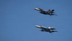 This US Navy handout photo released by US Central Command public affairs on March 12, 2026, shows two F/A-18E Super Hornets, attached to Strike Fighter Squadron (VFA) 14, as they fly over Nimitz-class aircraft carrier USS Abraham Lincoln (CVN 72) in support of Operation Epic Fury, on March 7, 2026. The United States and Israel launched a wave of strikes against targets in Iran on February 28, sparking swift retaliation by the Islamic republic which responded with missile attacks across the region. (Photo by US NAVY/AFP)/RESTRICTED TO EDITORIAL USE - MANDATORY CREDIT "AFP PHOTO/US NAVY and US CENTRAL COMMAND/HANDOUT" - HANDOUT - NO MARKETING NO ADVERTISING CAMPAIGNS - DISTRIBUTED AS A SERVICE TO CLIENTS