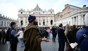 A pilgrim prays during Pope Leo XIV's Sunday Angelus prayer in St. Peter's Square at the Vatican on March 15, 2026. (Photo by Filippo MONTEFORTE/AFP)