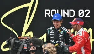 Winner Mercedes' Italian driver Kimi Antonelli (2nd R) and third-placed Ferrari's British driver Lewis Hamilton (R) speak after the Formula One Chinese Grand Prix at the Shanghai International Circuit in Shanghai on March 15, 2026. (Photo by HECTOR RETAMAL/AFP)