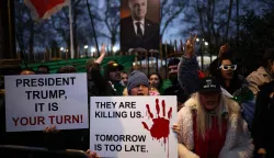 Anti-Iranian regime protesters wave Iranian flags during a gathering outside the Iranian Embassy, central London, on January 12, 2026. (Photo by Henry NICHOLLS/AFP)