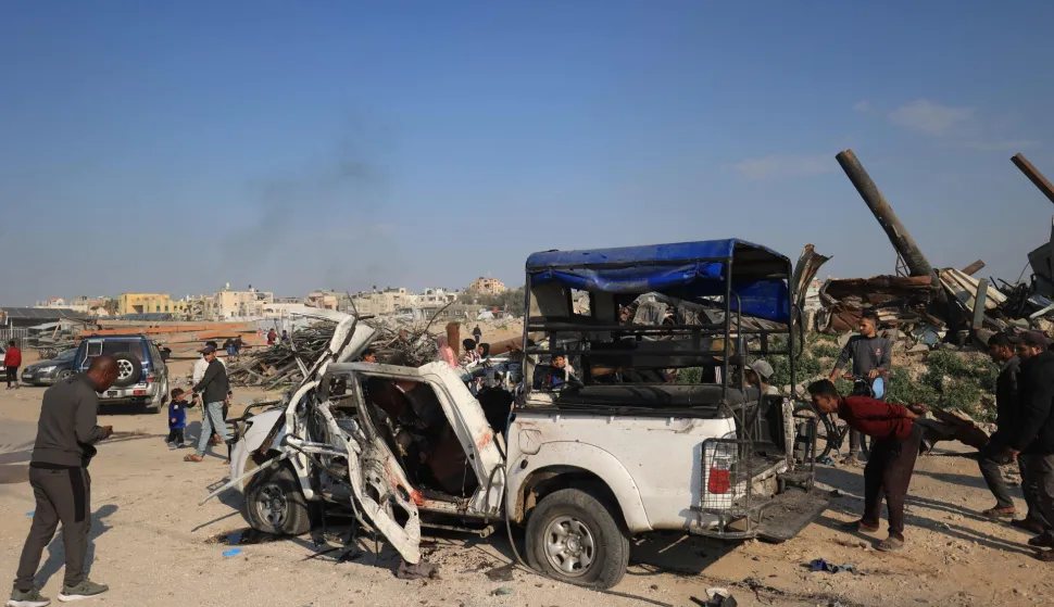 Palestinians inspect the site of an Israeli strike that targeted a police vehicle in Zawaida in the central Gaza Strip on March 15, 2026. The Al-Aqsa hospital in the central city of Deir al-Balah said in a statement that "eight martyrs arrived as a result of the targeting of a police vehicle in the town of Zawaida in the central Gaza Strip". Violence has continued in the war-shattered Palestinian territory despite a ceasefire which came into effect on October 10, with both Israel and Hamas regularly accusing the other of violations. (Photo by Eyad Baba/AFP)