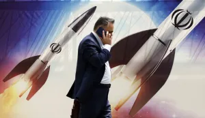 epa11281649 An Iranian man walks past an anti-Israel banner carrying pictures of Iranian missiles, in Tehran, Iran, 16 April 2024. Iranian President Ebrahim Raisi on 14 April said any new targeting of his country will be met with stronger response, after Iran's Islamic Revolutionary Guards Corps (IRGC) launched drones and rockets towards Israel late on 13 April. The Israeli Chief of the General Staff LTG Herzi Halevi said on 15 April the Iranian launch of missiles and drones against Israel will be met with a response. EPA/ABEDIN TAHERKENAREH