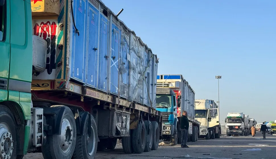 Trucks transporting portable toilets and humanitarian aid wait to enter through the Egyptian side of the Rafah border crossing with the Gaza Strip in northeastern Egypt on February 1, 2026. Israel partially reopened the Rafah crossing between the devastated Gaza Strip and Egypt on February 1, following months of urging from humanitarian organisations, though access is limited to the movement of people. (Photo by AFP)