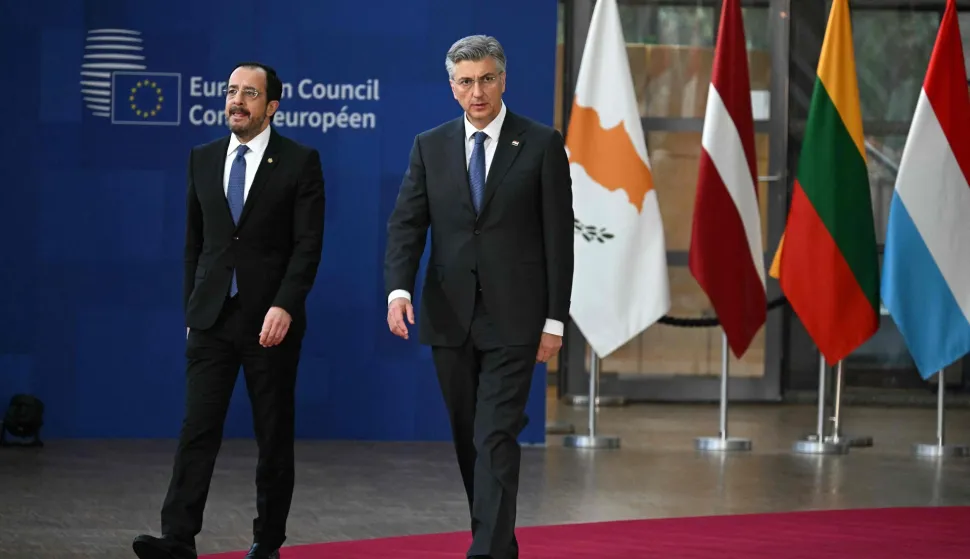 Cyprus' President Nikos Christodoulides and Croatia's Prime Minister Andrej Plenkovic arrive for a family picture during the EU Summit at the EU headquarters in Brussels, on March 19, 2026. European Union leaders meet in the context of the US-Israeli war against Iran that is consuming the Middle East, and its consequences on energy prices and security. (Photo by NICOLAS TUCAT/AFP)