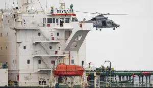 This handout photo taken and released on March 20, 2026, by the Etat Major des Armees (The French Defense Staff) shows a helicopter of the French Navy hovering over the Mozambican-flagged oil tanker Deyna during an interception operation in the western Mediterranean Sea. The French Navy intercepted an oil tanker sailing from Russia in the Mediterranean on March 20, 2026, maritime authorities said. The Mozambican-flagged Deyna, which sailed from Murmansk in northwestern Russia, was inspected over the regularity of its flag and will be escorted to an anchorage for further checks, the maritime prefecture added. (Photo by Etat Major des Arm?es/AFP)/RESTRICTED TO EDITORIAL USE - MANDATORY CREDIT "AFP PHOTO/ETAT MAJOR DES ARMEES" - HANDOUT - NO MARKETING NO ADVERTISING CAMPAIGNS - DISTRIBUTED AS A SERVICE TO CLIENTS