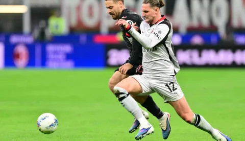 Torino's Croatian midfielder #10 Nikola Vlasic fights for the ball with AC Milan's French midfielder #12 Adrien Rabiot during the Italian Serie A football match between AC Milan and Torino at San Siro stadium in Milan, northern Italy, on March 21, 2026. (Photo by Stefano RELLANDINI/AFP)