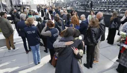 Attendees embrace during a commemoration ceremony for the March 2016 terror attacks at the memorial monument on Rue de la Loi (Wetstraat) in Brussels on March 22, 2026. Belgium is marking the tenth anniversary of the 2016 jihadist bombings in Brussels, a trauma that still scars the country and that authorities say sharpened focus on intelligence and counterterrorism. (Photo by NICOLAS MAETERLINCK/Belga/AFP)/Belgium OUT