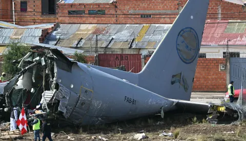 TOPSHOT - Rescue teams and military personnel work at the site of the crash of the Bolivian Air Force Lockheed C-130 plane (FAB-81) in El Alto, near La Paz, on February 28, 2026. At least 20 people died on February 27 in a military plane crash in Bolivia that was carrying cash and crashed while landing at El Alto Airport, near La Paz, authorities reported. (Photo by AIZAR RALDES/AFP)