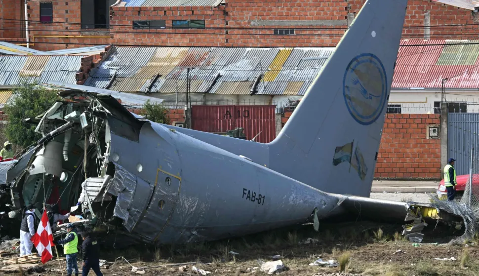 TOPSHOT - Rescue teams and military personnel work at the site of the crash of the Bolivian Air Force Lockheed C-130 plane (FAB-81) in El Alto, near La Paz, on February 28, 2026. At least 20 people died on February 27 in a military plane crash in Bolivia that was carrying cash and crashed while landing at El Alto Airport, near La Paz, authorities reported. (Photo by AIZAR RALDES/AFP)