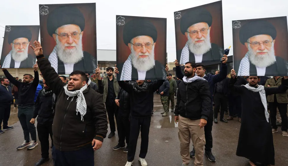 People hold portraits of the slain Iranian supreme leader Ayatollah Ali Khamenei while taking part during the funeral of the Hashd al-Shaabi operations commander for Al-Anbar, Saad Dawai in Baghdad on March 24, 2026. Fifteen fighters from the Hashd al-Shaabi were killed before dawn on March 24 in an ?American? strike on Al-Anbar province in western Iraq, according to an updated death toll published by this alliance of former paramilitaries, which includes pro-Iranian groups. Among the victims is ?the Hashd al-Shaabi operations commander for Al-Anbar, Saad Dawa?,? the alliance said in a statement. Iraq has been drawn into the Middle East war triggered by the US-Israel attack on its neighbour Iran on February 28. (Photo by AHMAD AL-RUBAYE/AFP)