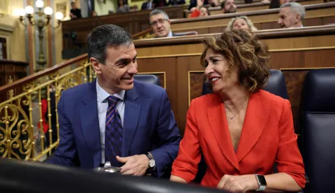 Spain's Prime minister Pedro Sanchez talks with Spain's deputy prime minister Maria Jesus Montero prior addressing parliament over the war in the Middle East at the congress in Madrid on March 25, 2026. Spanish Prime Minister Pedro Sanchez warned that the Middle East war presented a "far worse" scenario than the invasion of Iraq in 2003. (Photo by Thomas COEX/AFP)