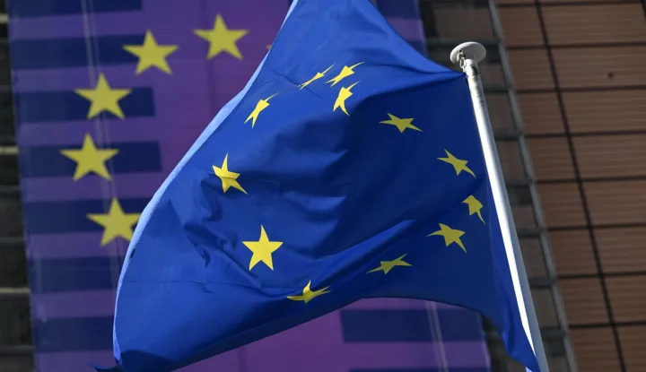 This photograph shows an European flag fluttering outside the EU Commission headquarters in Brussels on March 18, 2026. (Photo by Nicolas TUCAT/AFP)