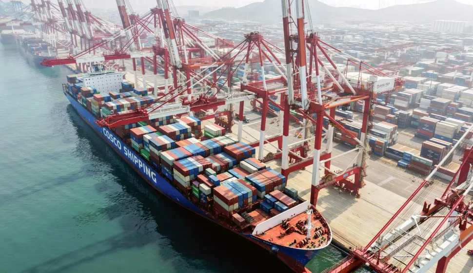 A cargo ship operated by Cosco Shipping is docked at the foreign trade container terminal of Qingdao Port, operated by Shandong Port Group, in China's eastern Shandong province on March 25, 2026. Chinese shipping giant Cosco said on March 25 that it was resuming new bookings for container shipments to some Gulf countries, after a three-week suspension in response to the Middle East war. (Photo by CN-STR/AFP)/China OUT
