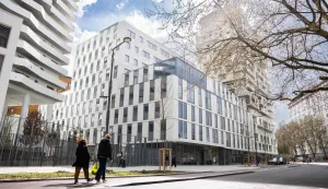 Pedestrians walk past the building intended to house the European Customs Authority in Lille, northern France, on March 25, 2026. Lille is competing to host the headquarters of the future European Customs Authority alongside Rome, Warsaw, Zagreb, Bucharest, The Hague, as well as Liege, Porto and Malaga. The choice of location will be made on March 25, 2026 in several stages, the European Council stated in a press release at the end of February. Firstly, the Council and the European Parliament will each select two of the candidate cities, without consulting one another. If the same city is selected by both institutions, it will automatically be chosen. In the event of a disagreement, the Council and the Parliament will proceed to a vote to reach a consensus. (Photo by Elise HOUBEN/AFP)
