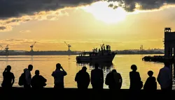 TOPSHOT - People watch the vessel Maguro -- symbolically renamed "Granma 2.0" as a tribute to the yacht used by Fidel Castro's guerrilla fighters to launch their revolution in 1956 -- as it arrives from Mexico with humanitarian aid as part of the Nuestra America convoy, docking at the port of Havana on March 24, 2026. (Photo by YAMIL LAGE/AFP)