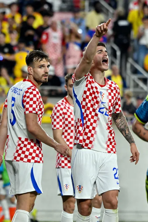 Croatia's defender #22 Luka Vuskovic (R) reacts as Croatia's defender #03 Marin Pongracic looks on during a friendly football match between Colombia and Croatia at Camping World Stadium in Orlando, Florida, on March 26, 2026. (Photo by Miguel J. Rodriguez CARRILLO/AFP)