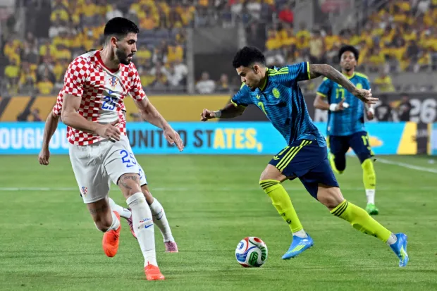 Colombia's forward #07 Luis Diaz controls the ball followed by Croatia's defender #25 Martin Erlic during a friendly football match between Colombia and Croatia at Camping World Stadium in Orlando, Florida, on March 26, 2026. (Photo by Miguel J. Rodriguez CARRILLO/AFP)