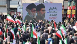Mourners participate in a procession during the funeral of Iran?s national security chief Ali Larijani, Basij commander Gholamreza Soleimani and Iranian sailors killed in recent strikes, in Tehran on March 18, 2026. After crowds gathered in central Tehran for the funeral of Iran's security chief Ali Larijani, Iran's new supreme leader Mojtaba Khamenei declared in a written message that his killers would pay. Larijani's funeral was held alongside those of Gholamreza Soleimani, the head of the Basij paramilitary force who was also killed in a strike in Iran this week, and dozens of Iranian sailors who were killed when US forces torpedoed their frigate off Sri Lanka earlier this month. (Photo by ATTA KENARE/AFP)/