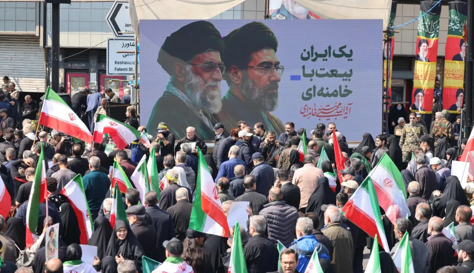 Mourners participate in a procession during the funeral of Iran?s national security chief Ali Larijani, Basij commander Gholamreza Soleimani and Iranian sailors killed in recent strikes, in Tehran on March 18, 2026. After crowds gathered in central Tehran for the funeral of Iran's security chief Ali Larijani, Iran's new supreme leader Mojtaba Khamenei declared in a written message that his killers would pay. Larijani's funeral was held alongside those of Gholamreza Soleimani, the head of the Basij paramilitary force who was also killed in a strike in Iran this week, and dozens of Iranian sailors who were killed when US forces torpedoed their frigate off Sri Lanka earlier this month. (Photo by ATTA KENARE/AFP)/