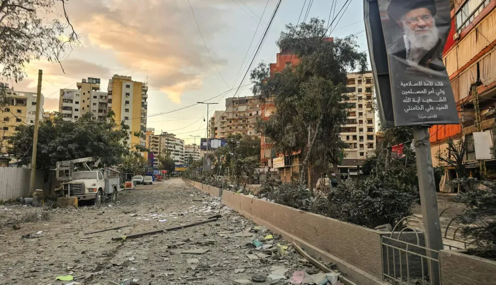 A photograph shows a portrait of Iran?s slain supreme leader Ayatollah Ali Khamenei along a street covered with debris following an Israeli airstrike in Beirut?s southern suburbs on March 28, 2026. Israel's military renewed its attacks on Beirut's southern suburbs on March 27, saying it was targeting Hezbollah infrastructure, as the Iran-backed group said the foes had clashed directly in the country's south. (Photo by AFP)/