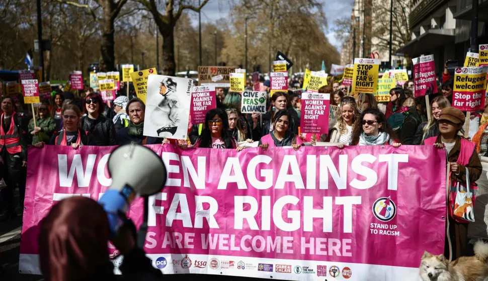 Protesters holding placards and waving flags take part in a march against the far right, organised by the Together Alliance, in central London on March 28, 2026. (Photo by Henry NICHOLLS/AFP)