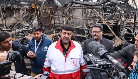 Pirhossein Kolivand, the head of the Iranian Red Crescent Society, speaks to journalists during the visit of a car service centre in eastern Tehran that was hit by a missile strike, on March 28, 2026. Israel and the United States launched strikes on Iran on February 28, killing the Islamic republic's supreme leader and sparking a war that has since spread across the Middle East. (Photo by ATTA KENARE/AFP)/