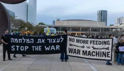 Demonstrators hold banners while gathering for the weekly anti-war protest at HaBima Square in Tel Aviv on March 28, 2026. The US and Israel launched strikes against Iran on February 28, sparking swift retaliation by the Islamic republic which responded with missile attacks across the region. (Photo by Ilia YEFIMOVICH/AFP)