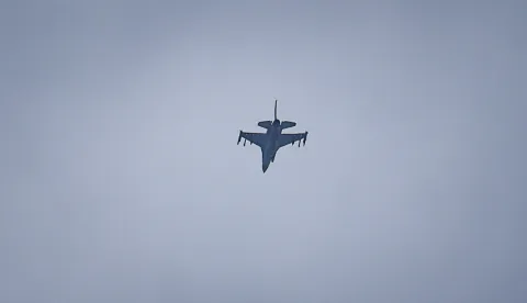 A United Arab Emirates Air Force F-16 fighter jet flies over Dubai on March 11, 2026. The Gulf countries have long been seen as islands of stability in the Middle East, but the war in the region could threaten their prosperity, analysts said, pointing to risks to their revenues and reputations as business havens. (Photo by AFP)/Attention editors: AFP covers the war in the Middle East through its extensive regional network, including bureaus in Tehran, Jerusalem, and several neighboring countries. Since the start of the conflict, journalists have been working under increasingly restrictive conditions. Authorities in several countries have limited reporters' movements, photo and live video coverage from sensitive locations. Some governments and armed groups have banned images of missile or drone strikes and other security-related sites./