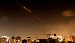 Rocket trails are seen in the sky above the Israeli coastal city of Netanya amid a fresh barrage of Iranian missile attacks late on March 27, 2026. Emergency responders said a man was killed in Israel on March 28 after the Israeli military reported missiles fired from Iran. (Photo by JACK GUEZ/AFP)/