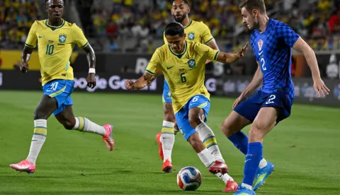 Brazil's defender #06 Douglas Santos moves the ball past Croatia's defender #02 Josip Stanisic during a friendly football match between Brazil and Croatia at Camping World Stadium in Orlando, Florida, on March 31, 2026. (Photo by MIGUEL J RODRIGUEZ CARRILLO/AFP)