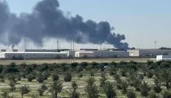 TOPSHOT - Smoke rises from an area of Kuwait's international airport after a reported drone strike on April 1, 2026. Kuwait's civil aviation authority said that the Gulf state's international airport had come under an Iranian drone attack that led to "a large fire" at a fuel depot. (Photo by AFP)/Kuwait OUT/KUWAIT OUT
