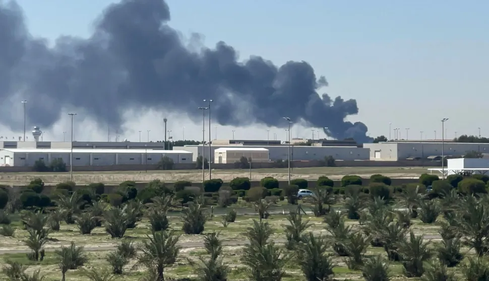 TOPSHOT - Smoke rises from an area of Kuwait's international airport after a reported drone strike on April 1, 2026. Kuwait's civil aviation authority said that the Gulf state's international airport had come under an Iranian drone attack that led to "a large fire" at a fuel depot. (Photo by AFP)/Kuwait OUT/KUWAIT OUT