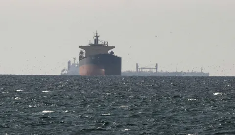Cargo ships in the Gulf, near the Strait of Hormuz, as seen from northern Ras al-Khaimah, near the border with Oman's Musandam governance, amid the U.S.-Israeli conflict with Iran, in United Arab Emirates, March 11, 2026. REUTERS/Stringer REFILE - CORRECTING "TANKERS" TO "CARGO SHIPS" AND REMOVING ACTION "SAIL". Photo: STRINGER/REUTERS