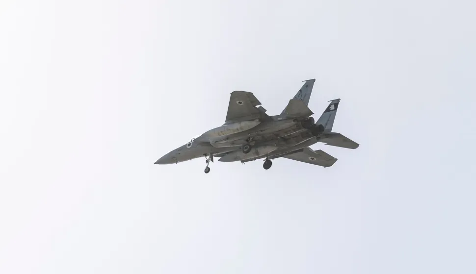 An Israeli Air Force F-15 fighter jet flies over the outskirts of Tel Aviv on March 20, 2026. The United States and Israel began the war on February 28, 2026, by attacking Iran and killing its supreme leader. Iran retaliated with strikes against Israel and US allies and interests across the Gulf and Iraq, drawing the whole region into war (Photo by Ilia YEFIMOVICH/AFP)/