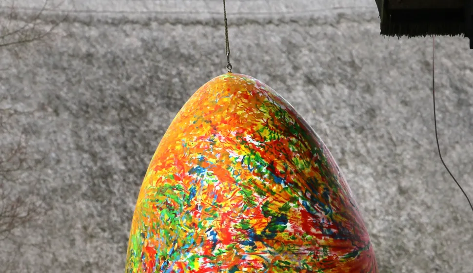 Two women stand underneath a 2.20 meter large giant Easter egg at the open-air museum in Klockenhagen, Germany, 30 March 2012. The egg is part of a special exhibition "The Egg and the Cup". The open-air museum opens its barns, stalls and houses for the new season on 01 April 2012. Photo: Bernd Wuestneck/DPA/PIXSELL