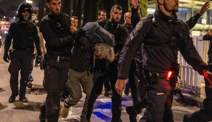 Israeli police arrest a demonstrator at HaBima Square in Tel Aviv on April 4, 2026, protesting against the ongoing war with Iran. Carrying anti-war banners and chanting slogans against Prime Minister Benjamin Netanyahu, hundreds of Israelis rallied in Tel Aviv on April 4 to protest the war with Iran. Since February 28, the United States and Israel have conducted joint strikes against Iran, prompting the Islamic Republic to retaliate with daily missile barrages targeting Israel and several neighbouring countries across the region. (Photo by Ilia YEFIMOVICH/AFP)/