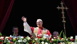 TOPSHOT - Pope Leo XIV waves to the crowd from the main balcony of St. Peter's basilica for the Urbi et Orbi message and blessing to the city and the world as part of Easter celebrations, at St Peter's square in the Vatican on April 5, 2025. (Photo by Alberto PIZZOLI/AFP)