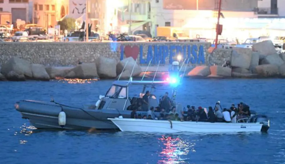 epa10870038 A small boat with migrants is escorted by an Italian patrol boat in the harbor of Lampedusa, Italy, 19 September 2023. According to Italy's Interior Ministry, nearly 126,000 immigrants and refugees have entered the country as of 2023, more than twice as many as during the same time period in 2022. EPA/CIRO FUSCO