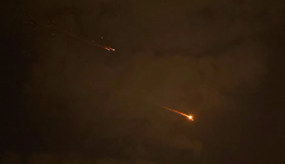 Rocket trails are seen in the sky above the Israeli coastal city of Netanya amid a fresh barrage of Iranian missile attacks on April 6, 2026. The Middle East was sparked by joint US-Israeli strikes on Iran that triggered a wave of retaliatory missile and drone attacks against Israel and several other countries in the region. (Photo by JACK GUEZ/AFP)/