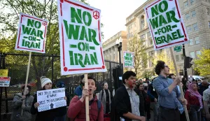 Demonstrators carry signs and chant slogans during a protest against US military action in Iran near the White House in Washington, DC, on April 7, 2026. On April 7, US President Donald Trump warned that "a whole civilization will die" in Iran if the country does not heed his midnight cutoff to open the Strait of Hormuz, as Tehran reported US-Israeli attacks on its infrastructure were already underway. (Photo by Mandel NGAN/AFP)
