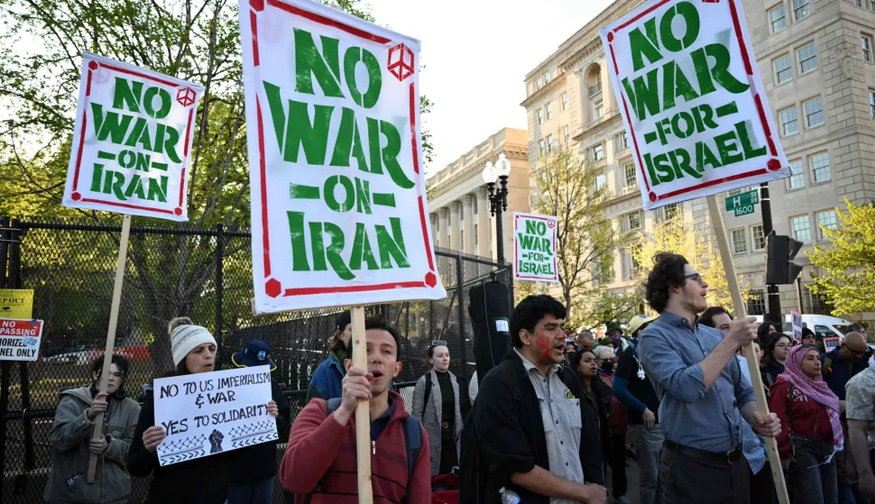 Demonstrators carry signs and chant slogans during a protest against US military action in Iran near the White House in Washington, DC, on April 7, 2026. On April 7, US President Donald Trump warned that "a whole civilization will die" in Iran if the country does not heed his midnight cutoff to open the Strait of Hormuz, as Tehran reported US-Israeli attacks on its infrastructure were already underway. (Photo by Mandel NGAN/AFP)