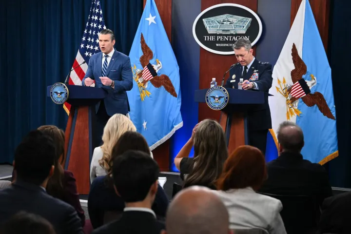 (L/R) US Secretary of Defense Pete Hegseth speaks alongside Chairman of the Joint Chiefs of Staff General Dan Caine during a press briefing at the Pentagon in Washington, DC, on April 8, 2026. The United States and Iran agreed to a two-week ceasefire on April 7 barely an hour before President Donald Trump's deadline to obliterate the country, triggering global relief alongside apprehension. Tehran has agreed to temporarily reopen the Strait of Hormuz, through which much of the world's oil, gas and fertiliser passes, easing concerns for the battered global economy. (Photo by Mandel NGAN/AFP)
