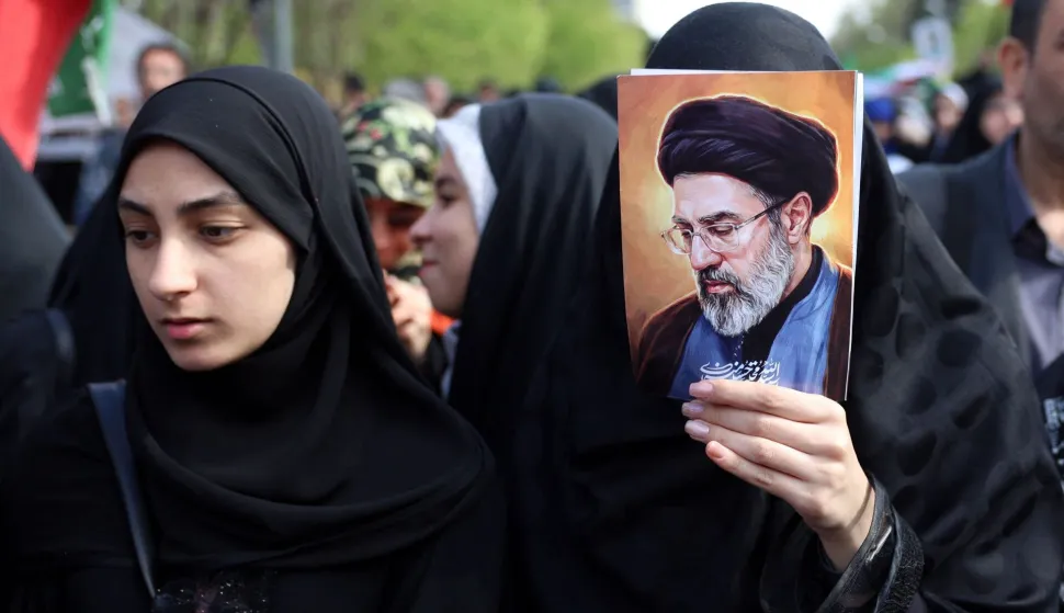 Iranians, one holding the image of Iranian supreme leader Mojtaba Khamenei, rally during a memorial, 40 days after the US-Israeli strike on a children?s school in the southern city of Minab on the first day of the war that killed at least 165 people, most of them children, in Tehran on April 7, 2026. On February 28, Israel and the United States launched strikes on Iran, killing its supreme leader and triggering a war that spread across the Middle East. (Photo by AFP)/